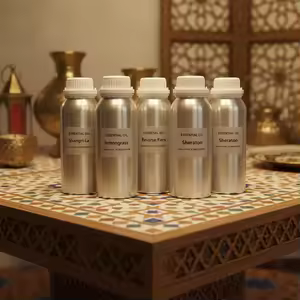 Aluminium refill drums of perfume oil on a mosaic table — a refill bar setup